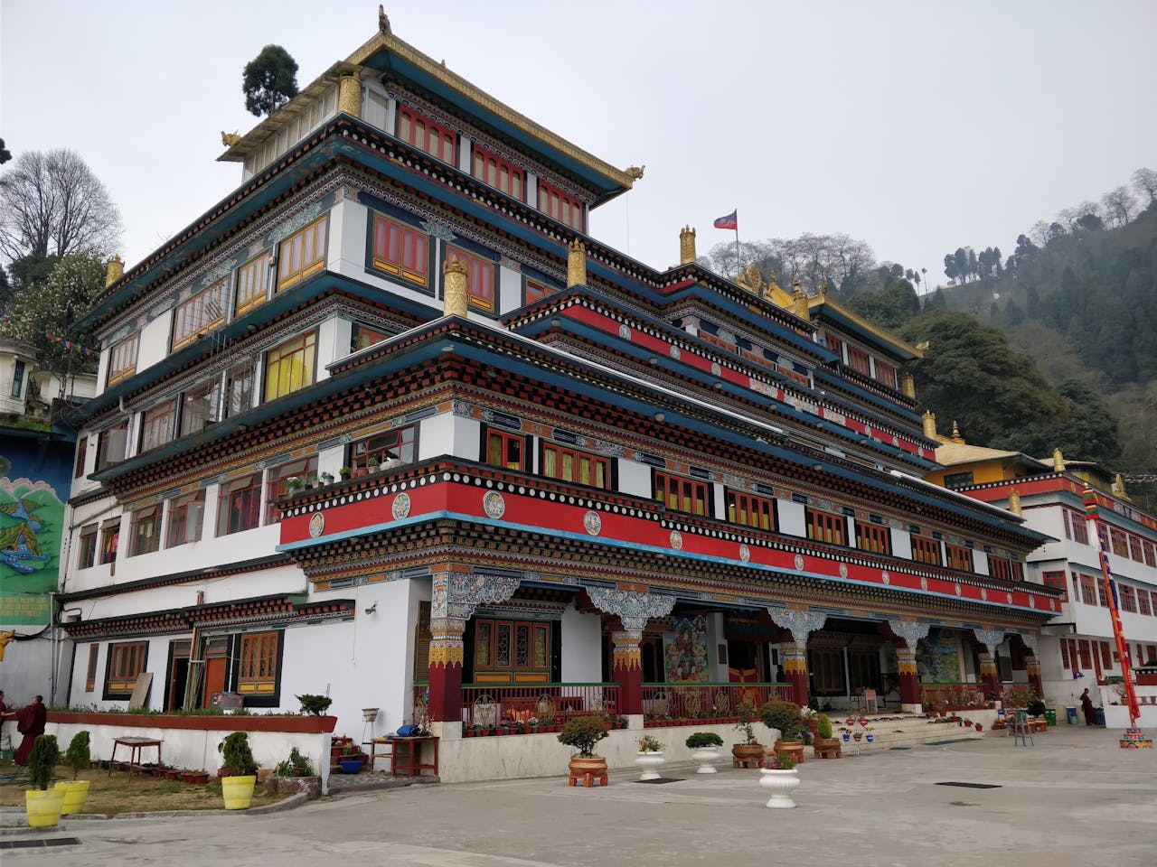 Mumbai to Kolkata Solar Panel Transport | HRC Beautiful Dali Monastery exterior in foggy Darjeeling, India with vibrant architecture.
