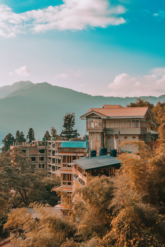 Moving Heavy Machinery from Delhi to Sikkim: How We Got It Done Stunning autumn view of hillside buildings in Gangtok, India with mountain backdrop.